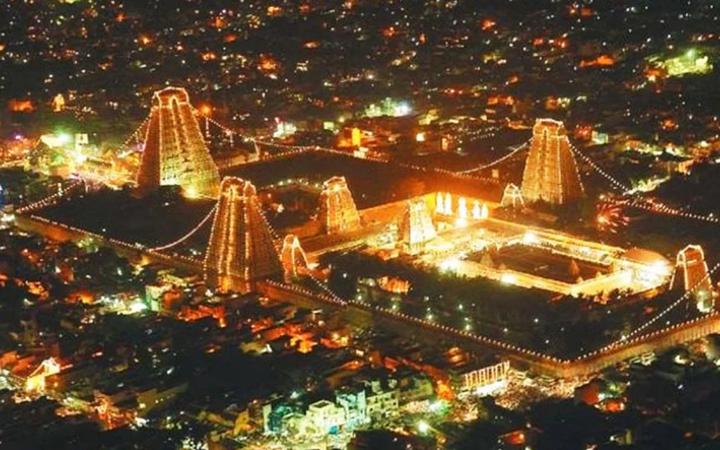 The sacred Maha Karthigai Deepam flame glowing atop Arunachala Hill at night during the Tiruvannamalai festival
