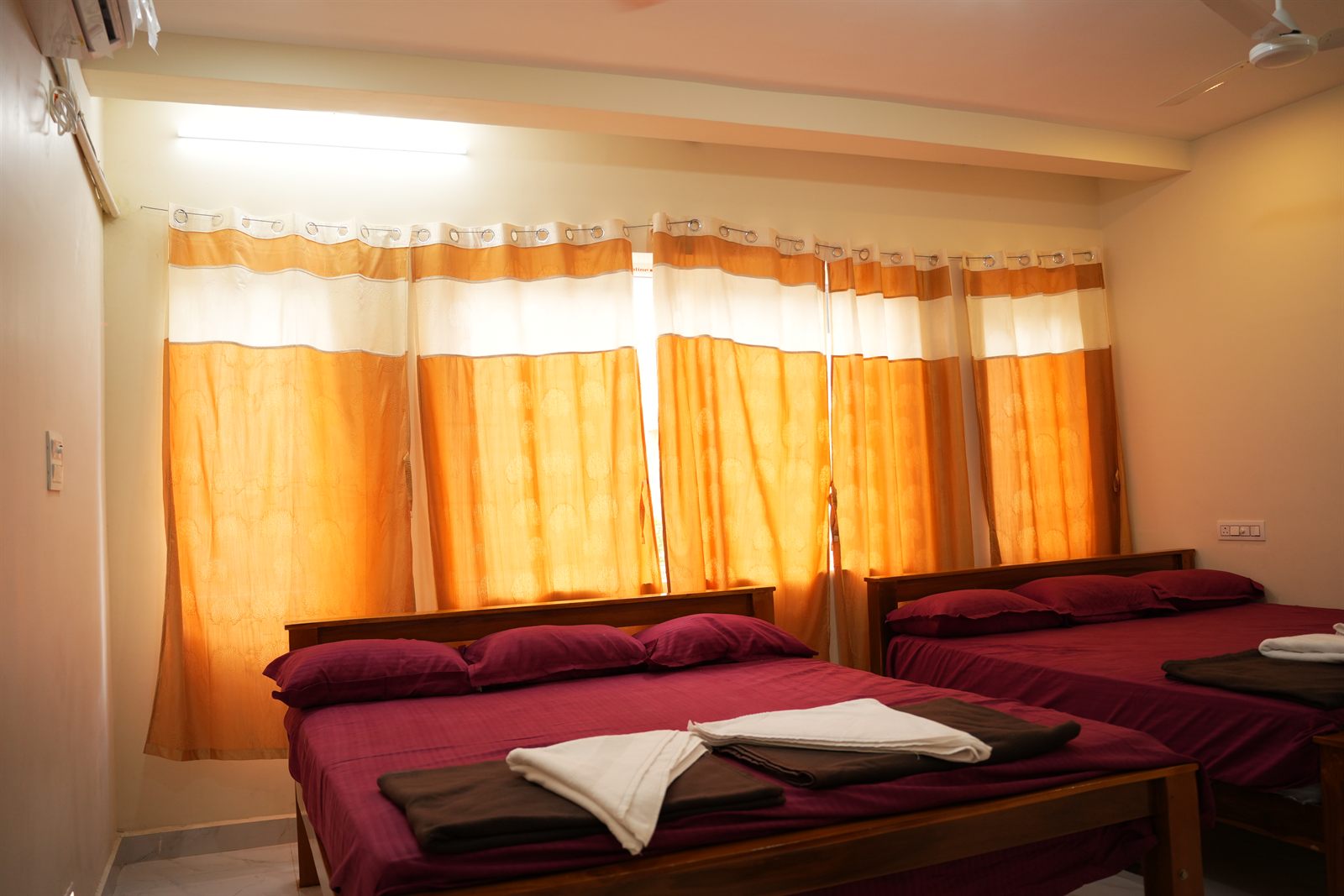 Family room at dusk with orange curtains glowing golden